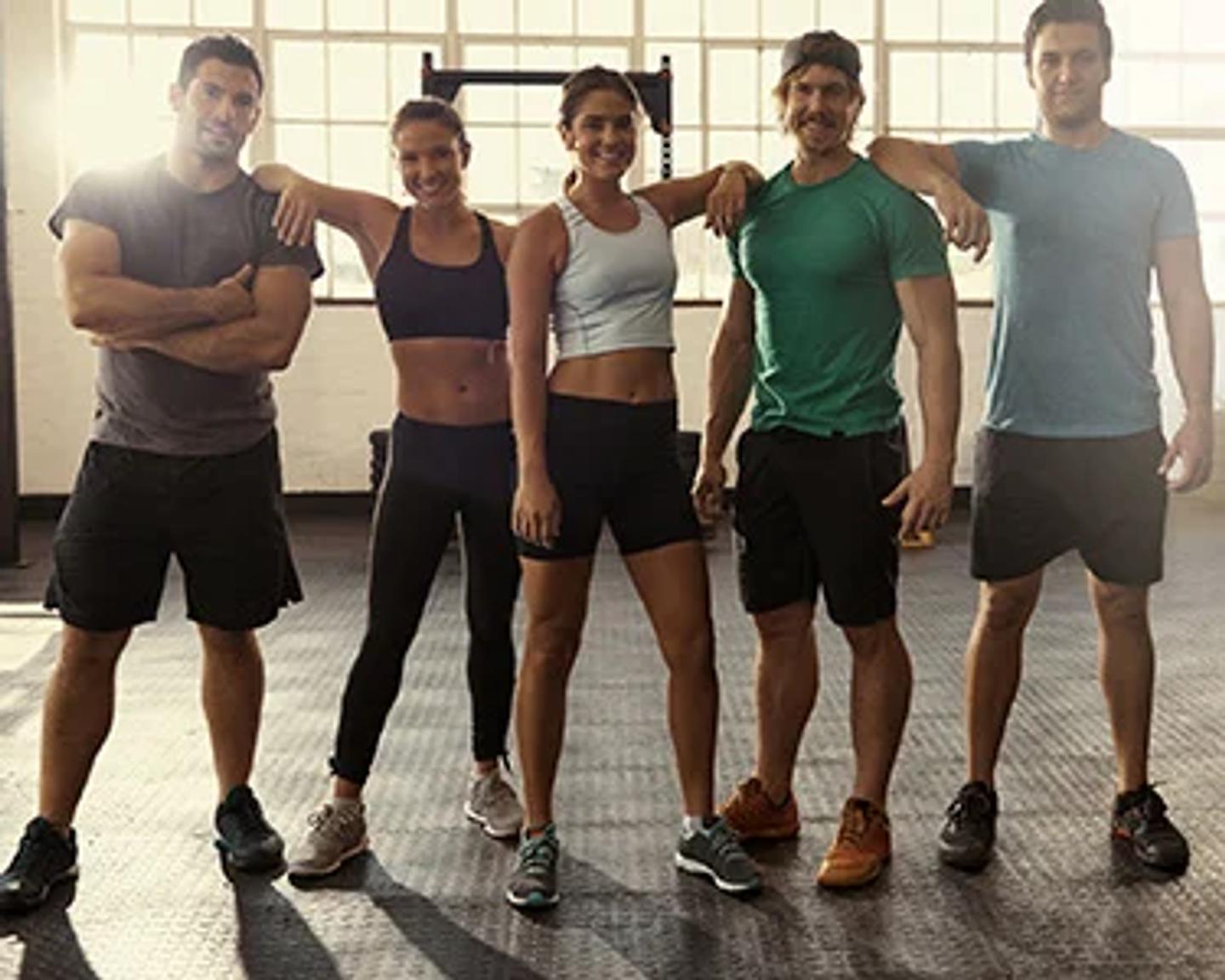 Group of ISSA Certified Personal Trainers posing for a photo in a gym