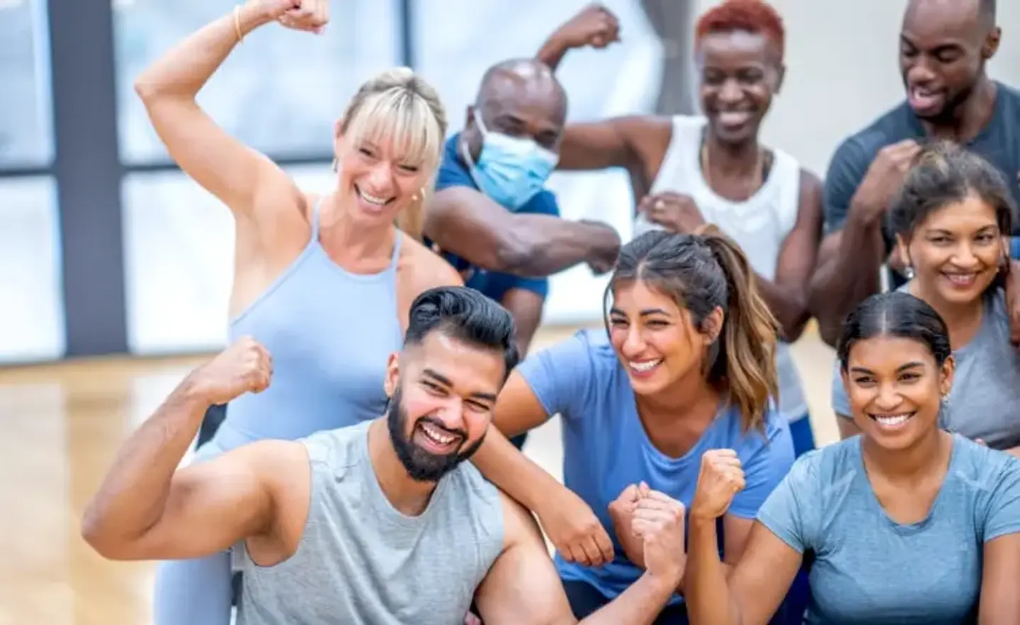 Group of diverse people smiling as they complete their fitness workout