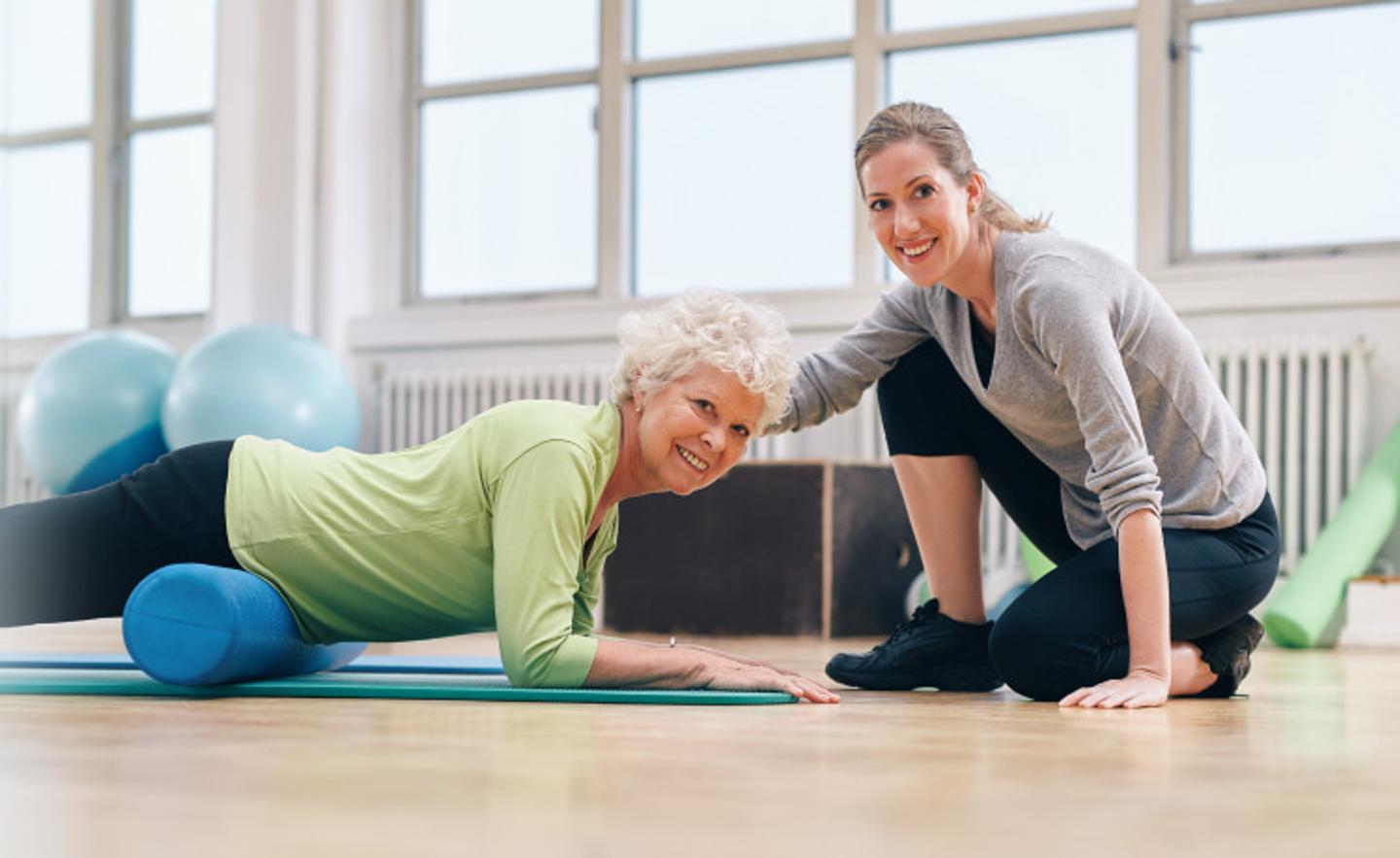 Senior Fitness Instructor teaching an elderly client