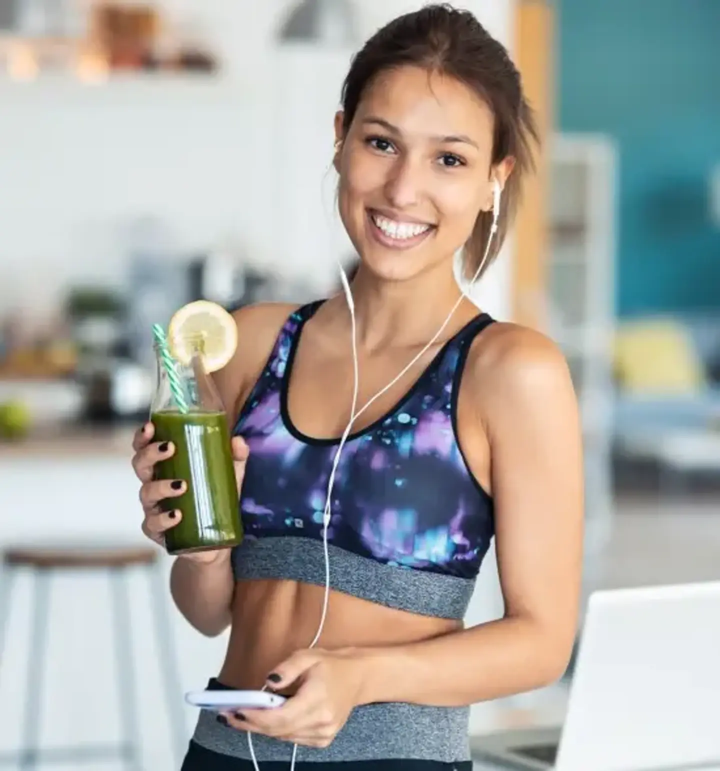 Woman Holding Healthy Drink While In Exercise Gear
