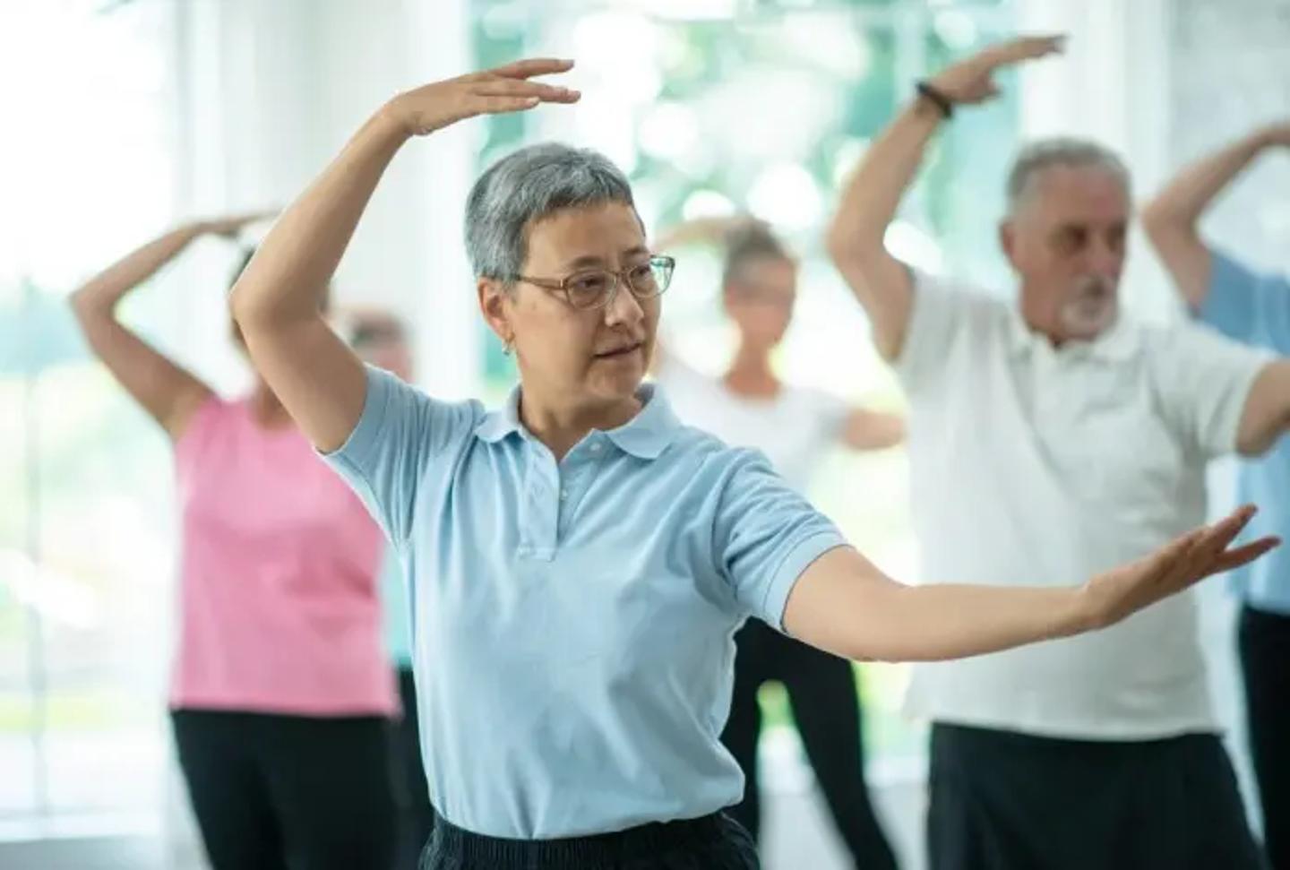 Senior adults practicing Tai Chi as a group